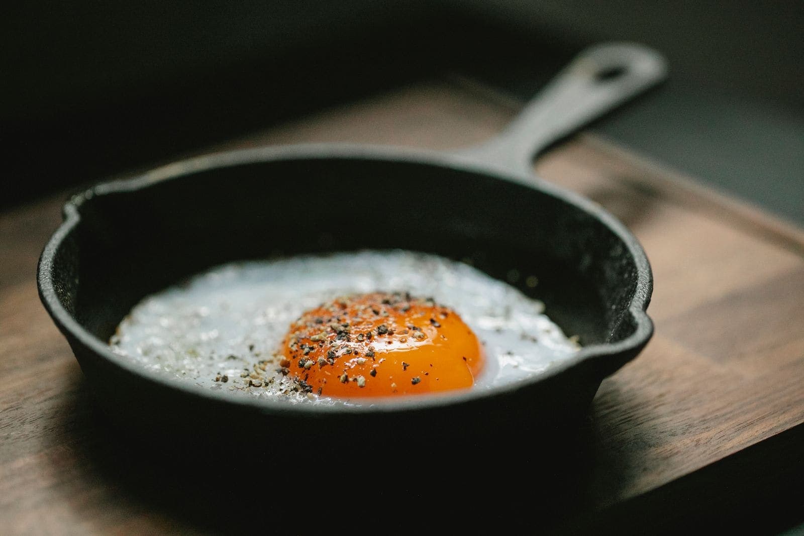 A fried egg with a just-set yolk in a small cast-iron skillet